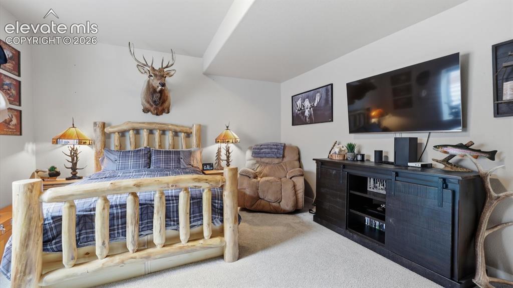 Image 40 of 50: A PRIVATE LOWER-LEVEL RETREAT — A spacious and inviting bedroom with the ad