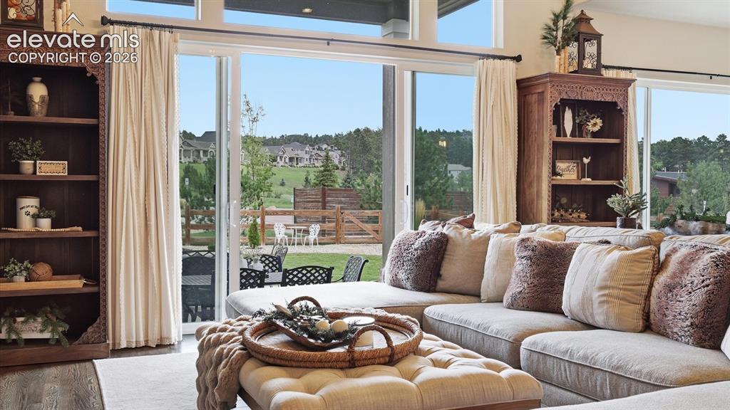 Image 5 of 50: MUST-SEE FEATURE! — Dramatic multi-panel sliding glass doors erase the boun