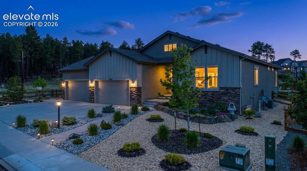 Image 50 of 50: Contemporary exterior featuring stone accents and vertical siding