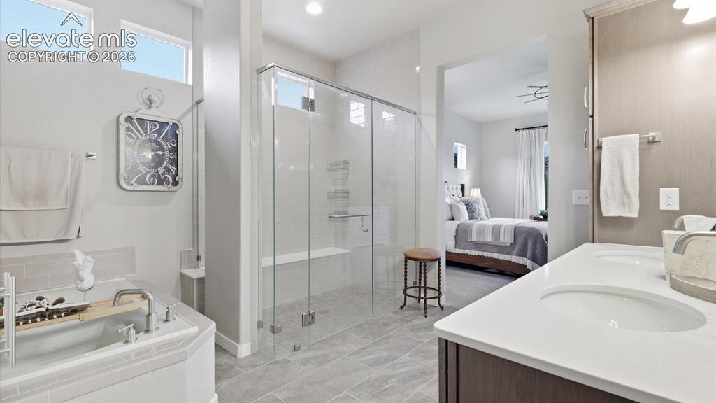 Image 8 of 50: A SANCTUARY AT HOME — This elegant primary bath offers a tranquil setting t