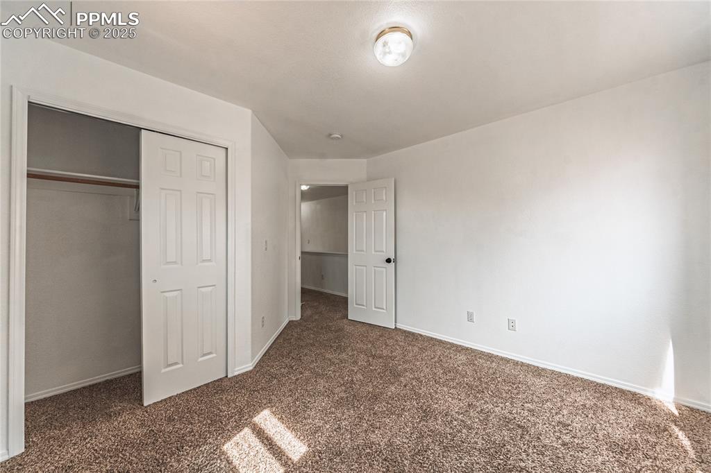 Image 42 of 47: Unfurnished bedroom with carpet floors, baseboards, and a closet