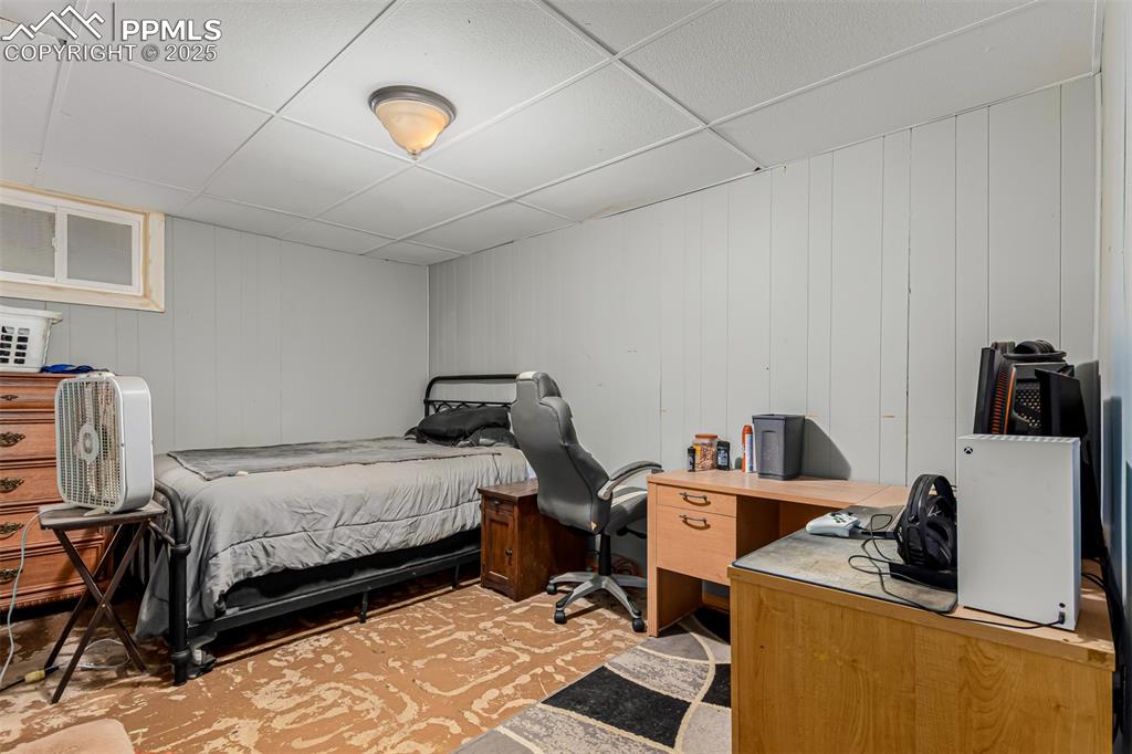 Image 10 of 17: Bedroom with a drop ceiling and an office area