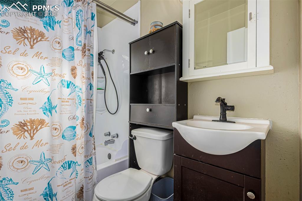 Image 12 of 17: Bathroom with shower / bath combo and vanity