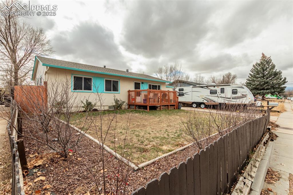 Image 16 of 17: Rear view of house featuring a deck and a shingled roof