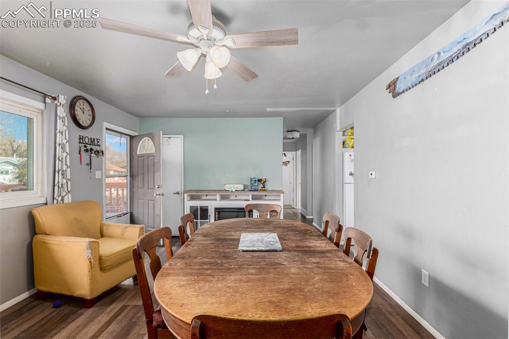 Image 6 of 17: Dining area with wood finished floors and ceiling fan