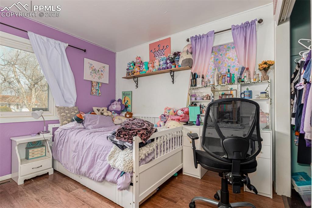 Image 9 of 17: Bedroom with wood finished floors