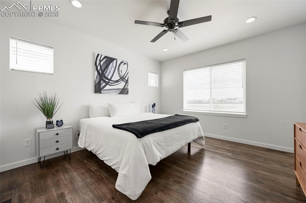 Image 19 of 38: Bedroom featuring dark wood-type flooring, recessed lighting, and ceiling f