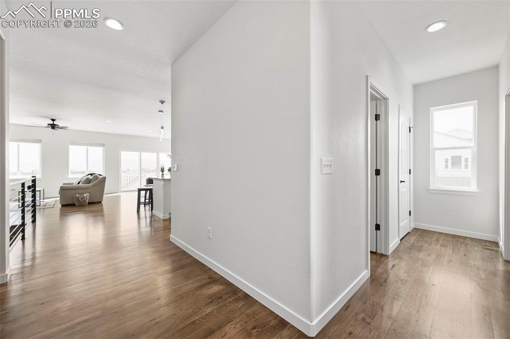 Image 6 of 38: Hallway featuring wood finished floors and recessed lighting