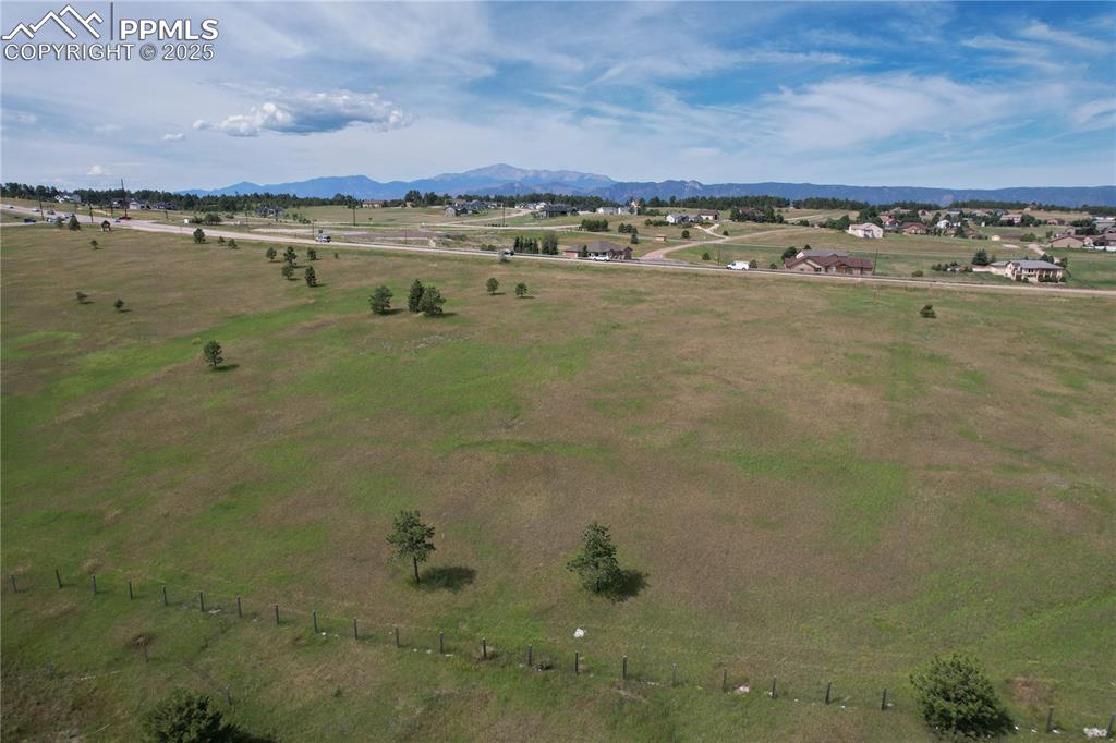 Image 11 of 29: Aerial view of sparsely populated area with mountains and agricultural land