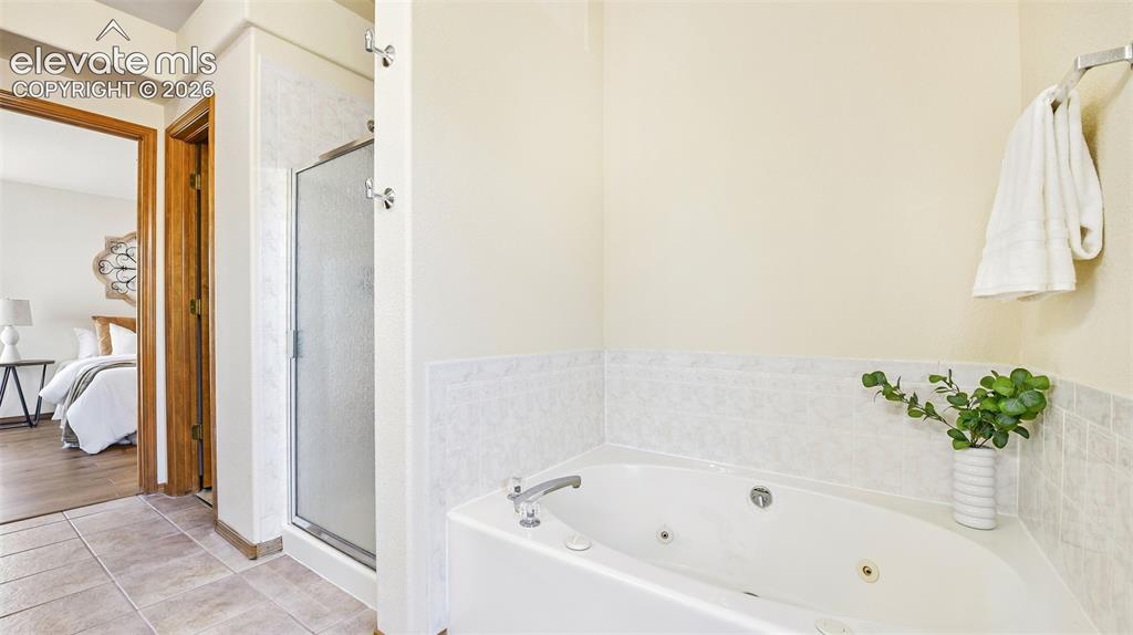 Image 20 of 42: …and attached primary 5-piece bath