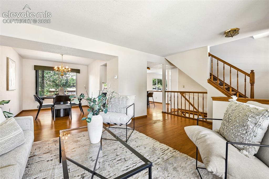 Image 5 of 42: Entry opens to living room with hardwood flooring!
