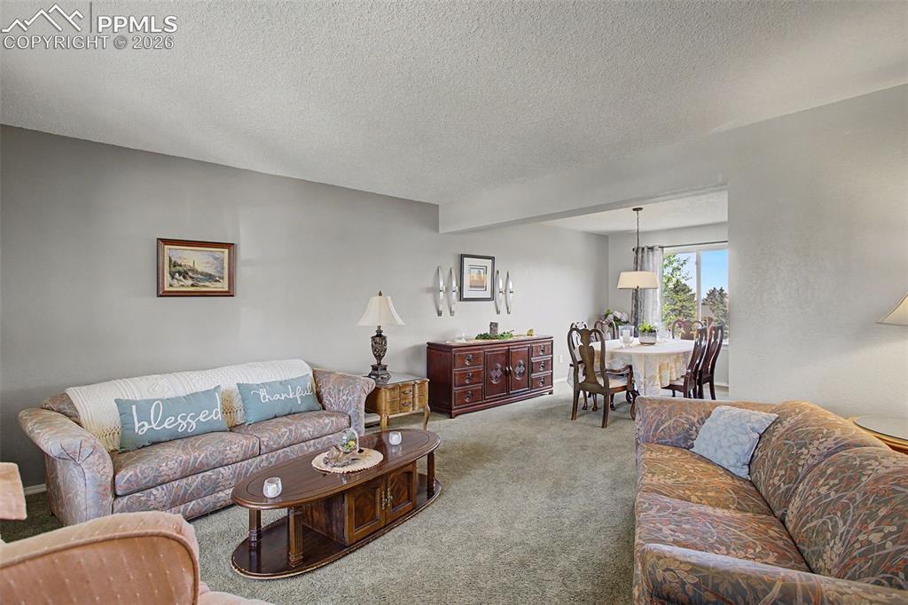 Image 10 of 46: Formal living room, looking through to formal dining.