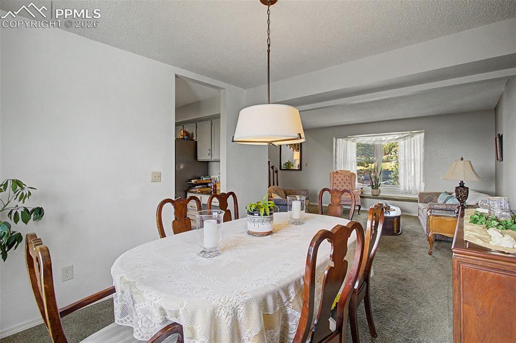 Image 11 of 46: Formal dining room, leading to the kitchen.