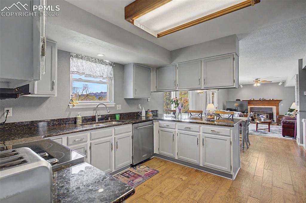 Image 12 of 46: Coming from the formal dining room, enter the kitchen, breakfast nook, and