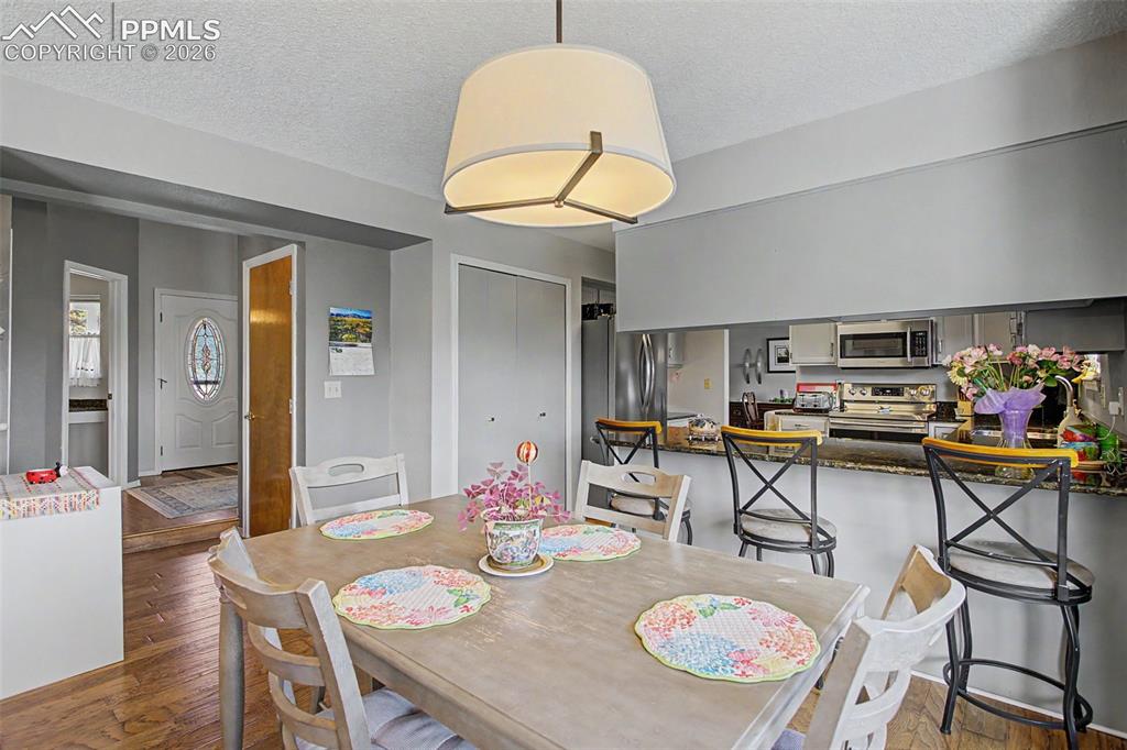 Image 16 of 46: Eat-in breakfast nook- archway/hallway leads back around to the front door/