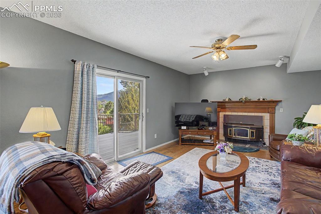 Image 17 of 46: Family room with a wood burning fireplace and walk-out access to the deck.