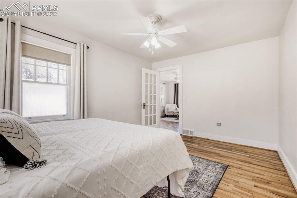 Image 14 of 34: Bedroom with light wood-style flooring and ceiling fan