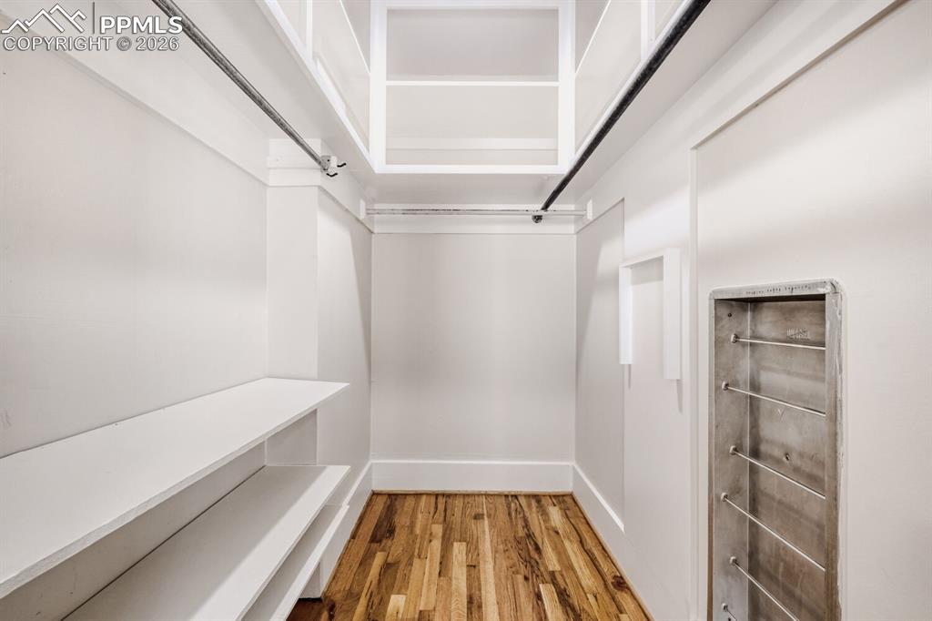 Image 15 of 34: Walk in closet featuring light wood-style floors