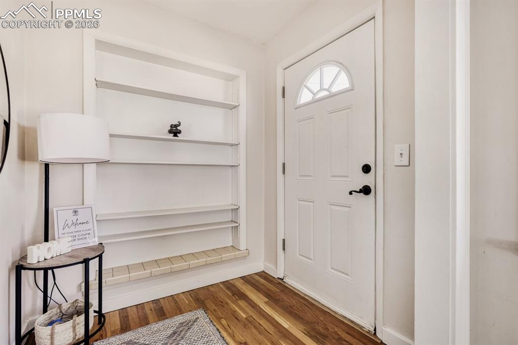 Image 2 of 34: Foyer entrance featuring light wood finished floors and baseboards