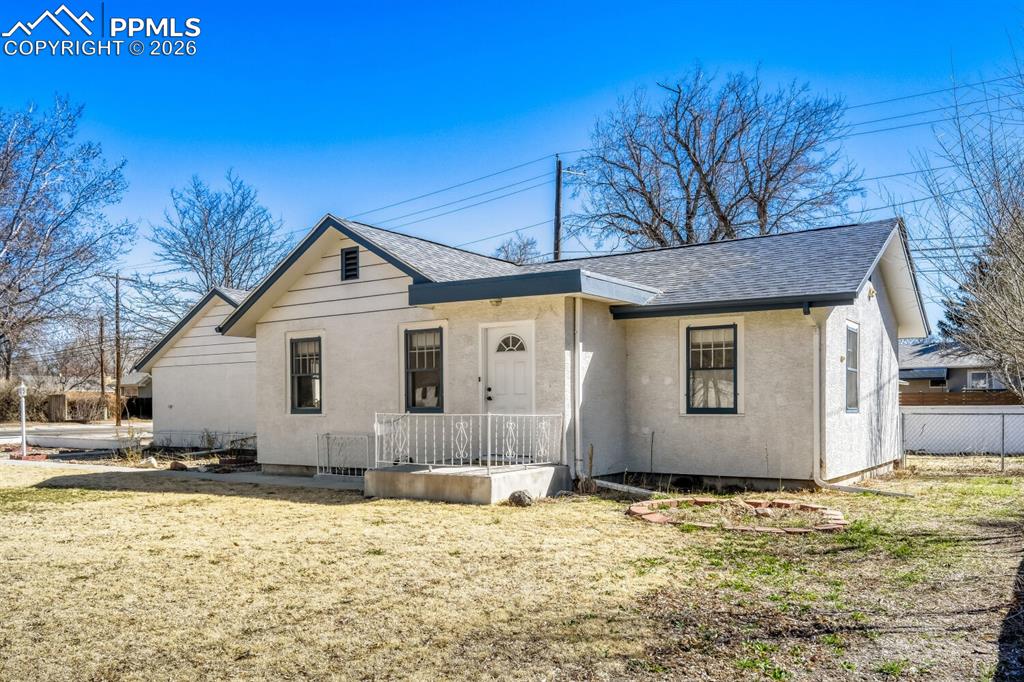 Image 26 of 34: Bungalow featuring roof with shingles and stucco siding