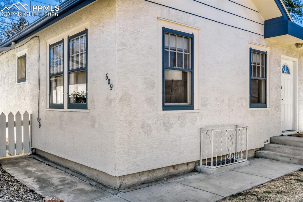 Image 28 of 34: View of side of home with stucco siding