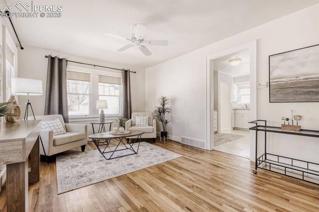 Image 3 of 34: Living area featuring light wood-style flooring and a ceiling fan
