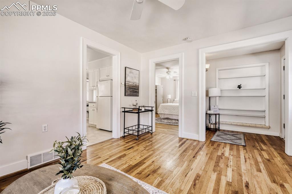 Image 5 of 34: Living area with ceiling fan and light wood finished floors