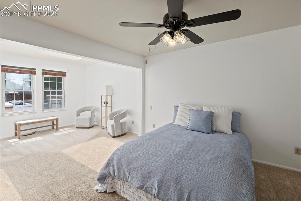 Image 13 of 31: Carpeted bedroom featuring baseboards and ceiling fan