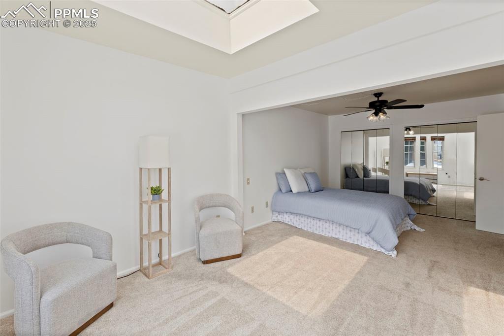 Image 16 of 31: Carpeted bedroom with multiple closets and a ceiling fan