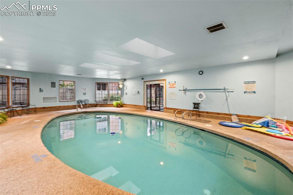 Image 31 of 31: Indoor community pool featuring a skylight