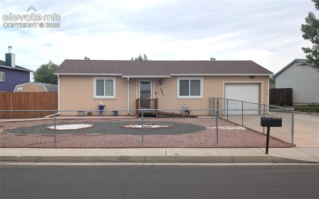 Image 1 of 16: Front of house, extra/RV parking, xeriscaped, handicap accessible ramp