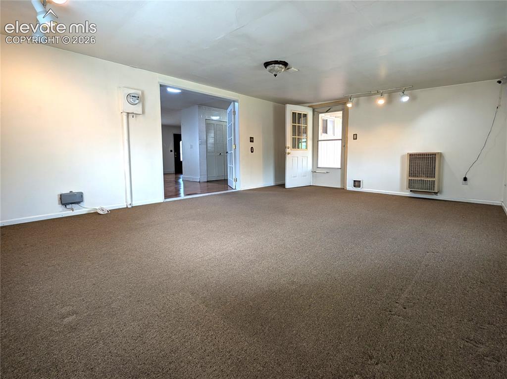 Image 10 of 16: Addition, heated, carpet, french doors to house, door to covered patio