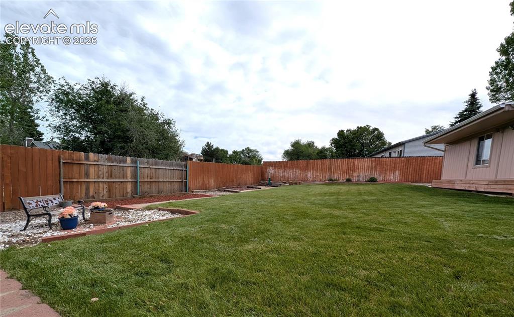 Image 11 of 16: Backyard, landscaped, fully fenced, sprinkler system