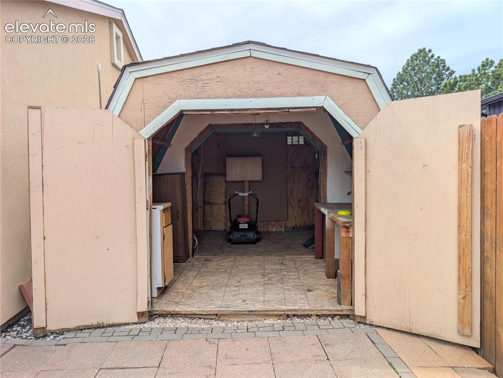 Image 14 of 16: Large shed with shelving, work bench, and electricity!
