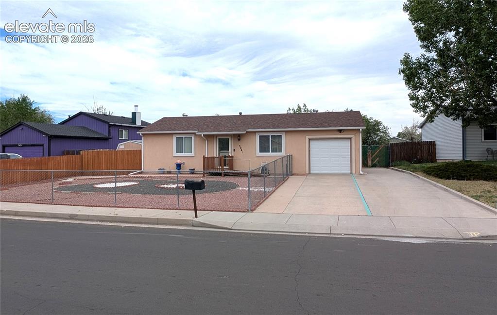 Image 2 of 16: Front of house, extra/RV parking, xeriscaped, handicap accessible ramp