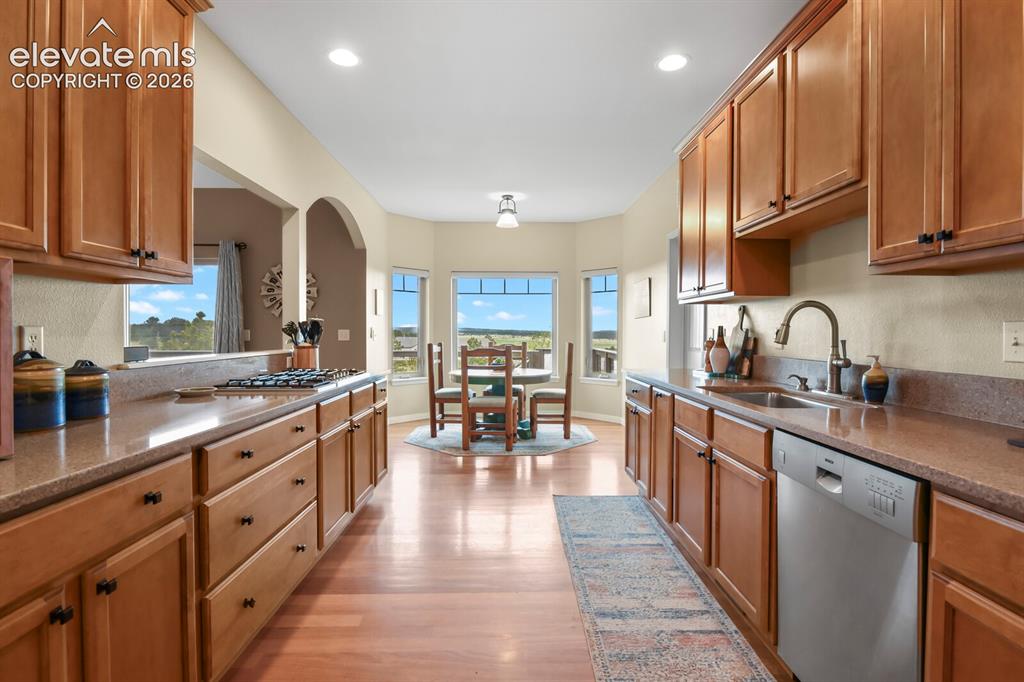 Image 10 of 45: Bright and functional kitchen with abundant cabinetry, updated finishes, an
