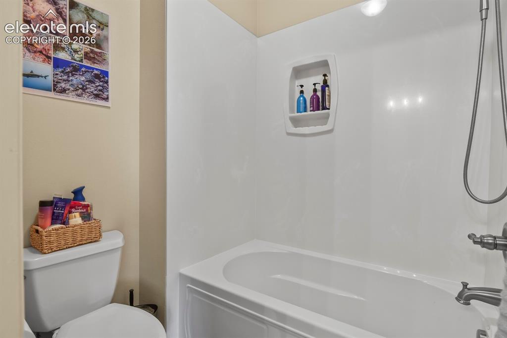 Image 17 of 45: Private primary en-suite full bath with tub/shower combination and updated 