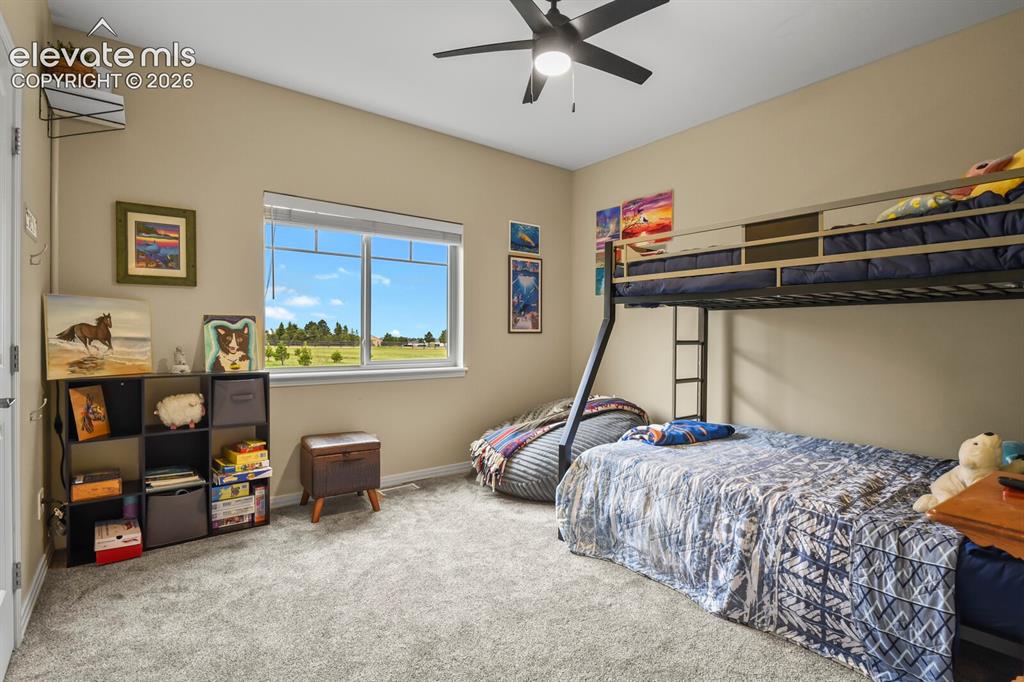 Image 20 of 45: Spacious secondary bedroom with natural light, neutral finishes, and peacef