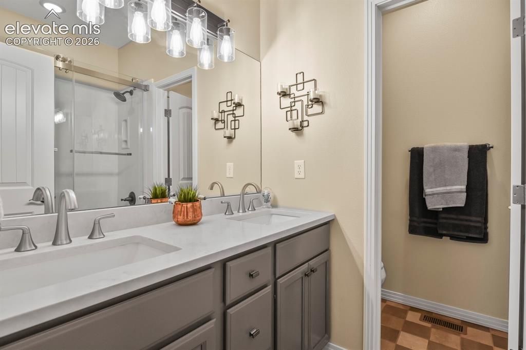 Image 21 of 45: Well-appointed hall full bath with updated finishes and convenient access t