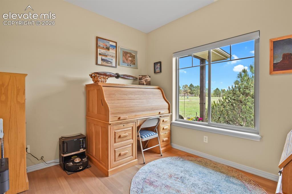 Image 22 of 45: Main-level office with natural light, hardwood flooring, and flexible space