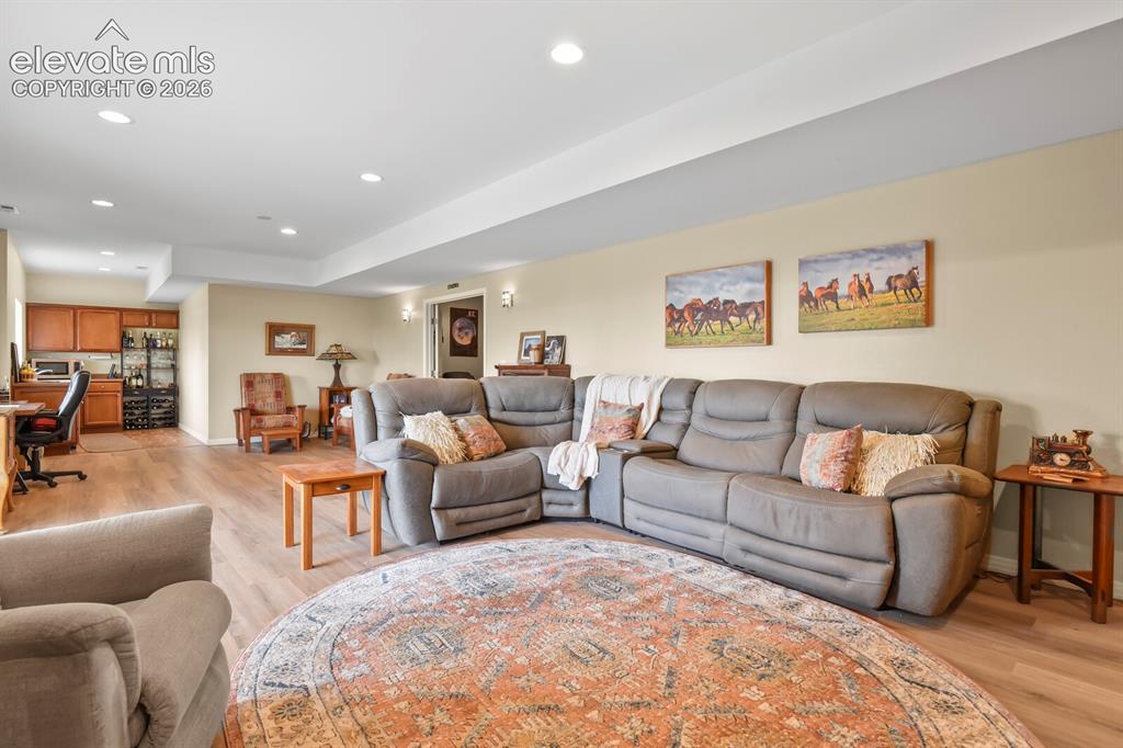 Image 28 of 45: Expansive walkout recreation room with abundant natural light and direct ac
