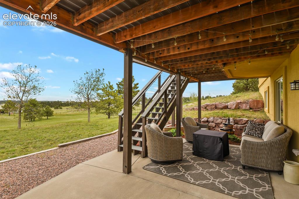 Image 35 of 45: Covered lower-level patio creates an ideal outdoor retreat for relaxing or 