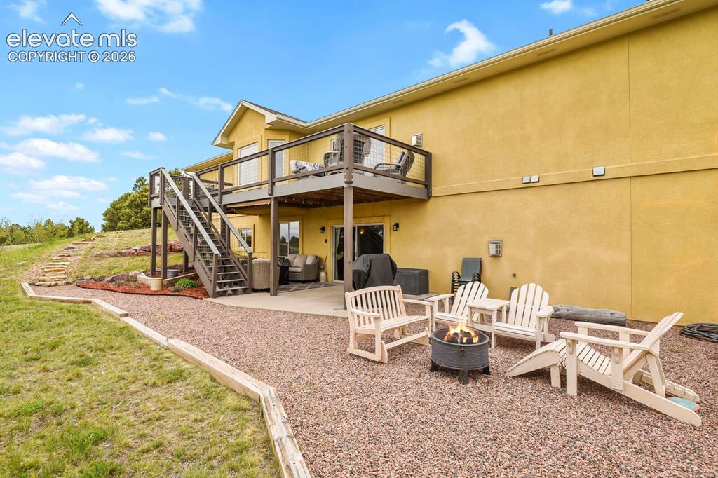 Image 36 of 45: Expansive rear exterior featuring a walk-out basement, covered patio, eleva
