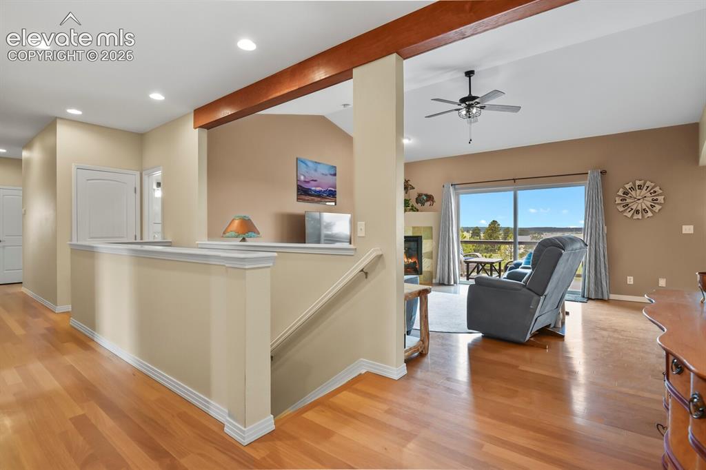 Image 7 of 45: Open-concept layout with hardwood flooring, staircase access to the walkout