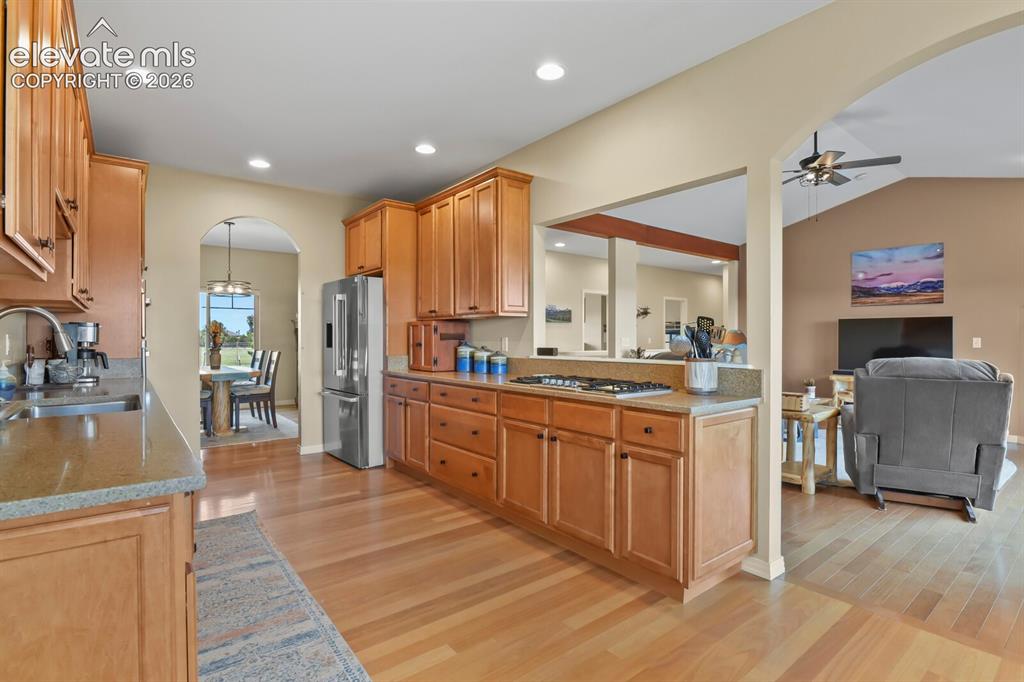 Image 9 of 45: Spacious open kitchen featuring quartz countertops, Bosch rangetop, GE Prof