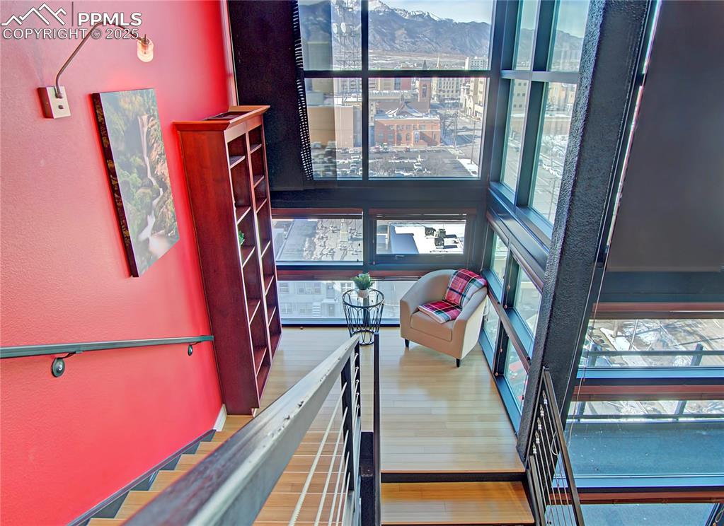 Image 17 of 32: Staircase featuring healthy amount of natural light, wood finished floors, 