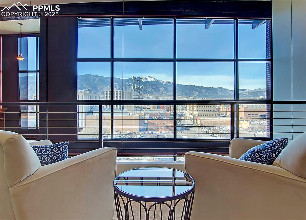 Image 21 of 32: Living room featuring a mountain view and healthy amount of natural light