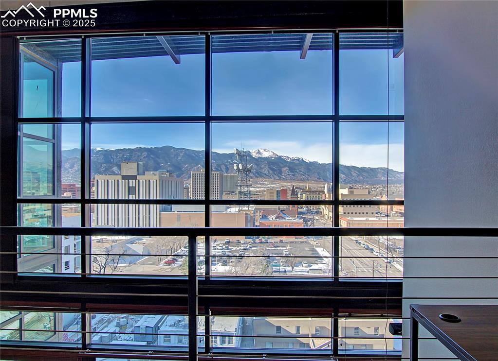 Image 24 of 32: Detailed view of a mountainous background and a city view