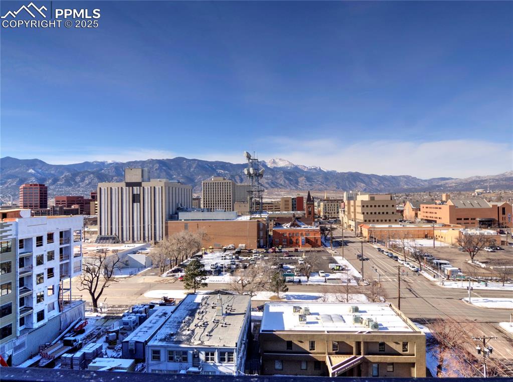 Image 26 of 32: View of city with a mountainous background