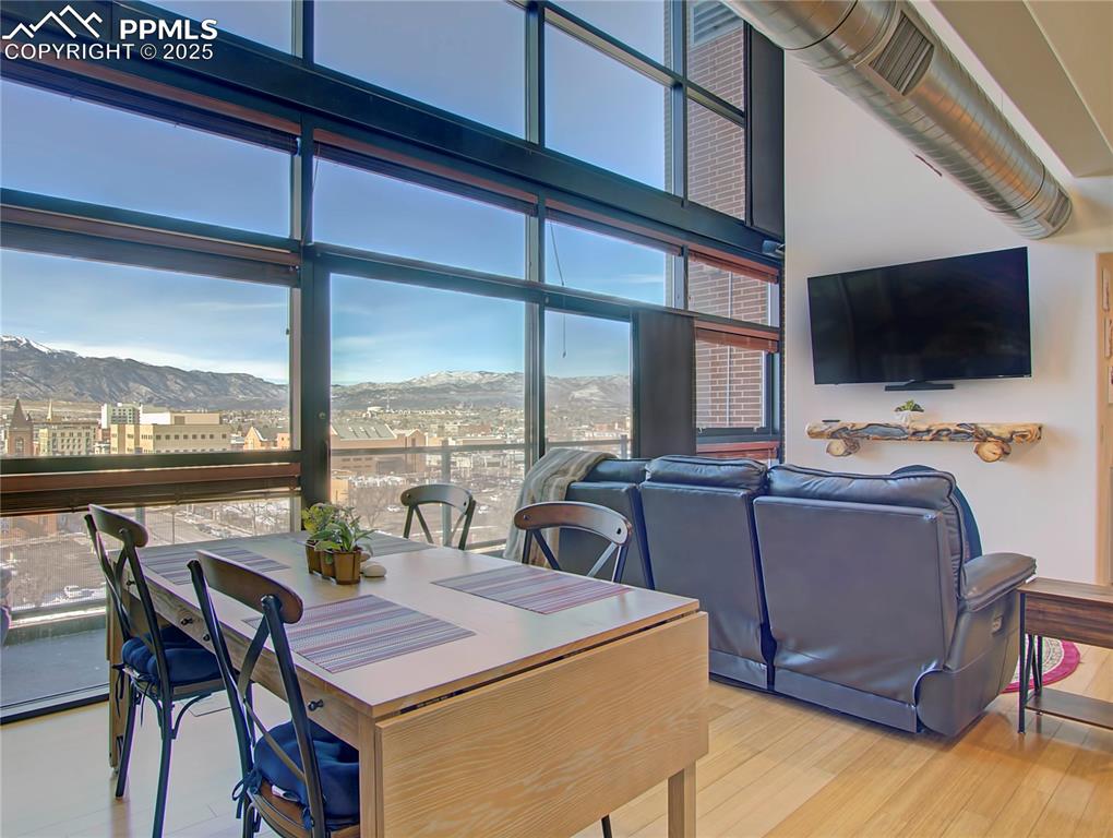 Image 9 of 32: Dining area featuring a mountain view, wood finished floors, and expansive 